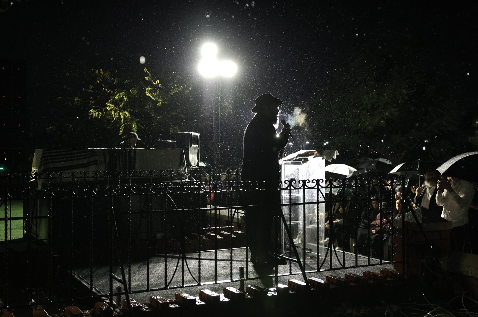 An Ultra-Orthodox Jewish Rabbi speaks beside the coffin of murdered Rabbi Zvi Kogan as rain falls during his funeral ceremony, in Kfar Chabad, near Tel Aviv, Israel,  Nov. 25, 2024. (EPA Photo)