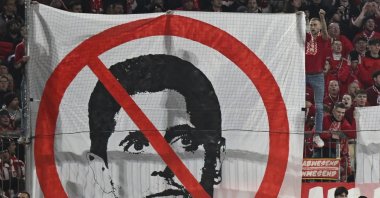 Munich fans hold up a banner against Nasser Al-Khelaifi, president of Paris Saint-Germain during the match between FC Bayern and Paris Saint Germain, at the Allianz Arena, Munich, Germany, Nov. 26, 2024. (AP Photo)