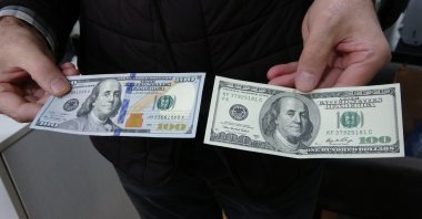 A man holds $100 bills in Bursa, northwestern Türkiye, Nov. 27, 2024. (IHA Photo)