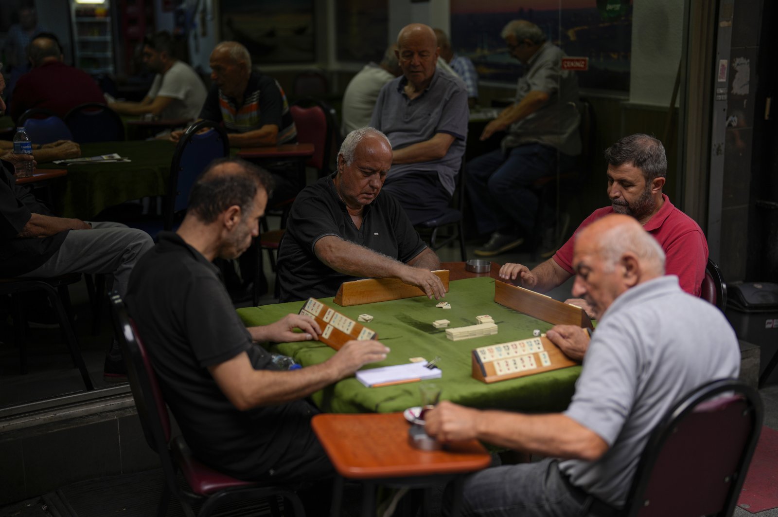 A group of men play a Rummikub game locally called &quot;Okey&quot; at Kadiköy neighborhood, Istanbul, Türkiye, Sept. 27, 2023. (AP Photo)