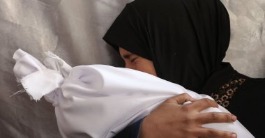 A Palestinian woman mourns as she holds the body of a relative killed in an Israeli strike at Al-Ahli Arab Hospital, also known as the Baptist Hospital, Gaza City, Palestine, Nov. 27, 2024. (AFP Photo)