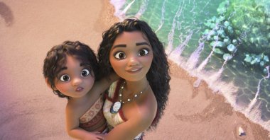 This image released by Disney shows the characters Moana, voiced by Auli&#039;i Cravalho, holding Simea, voiced by Khaleesi Lambert-Tsuda, in a scene from &quot;Moana 2.&quot; (AP Photo)