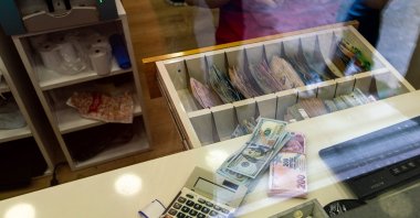 Dollar and Turkish lira banknotes are seen displayed at the currency exchange office, Istanbul, Türkiye, June 8, 2023. (Reuters Photo)