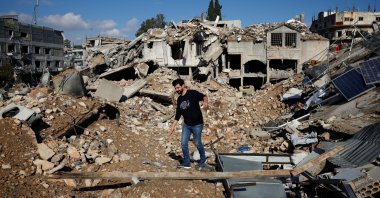 Ali Ali, 35, walks on the rubble of his shop destroyed in an Israeli strike, Nabatieh, southern Lebanon, Nov. 28, 2024. (Reuters Photo)