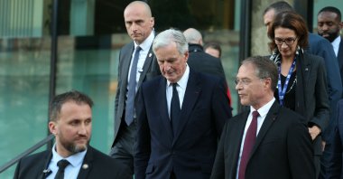 French Prime Minister Michel Barnier (C) and French General Confederation of Small and Medium Companies (CPME) President Francois Asselin (R) leave after attending the 5th Impact PME (small and medium businesses) event at the Station F in Paris, France, Nov. 28, 2024. (AFP Photo)