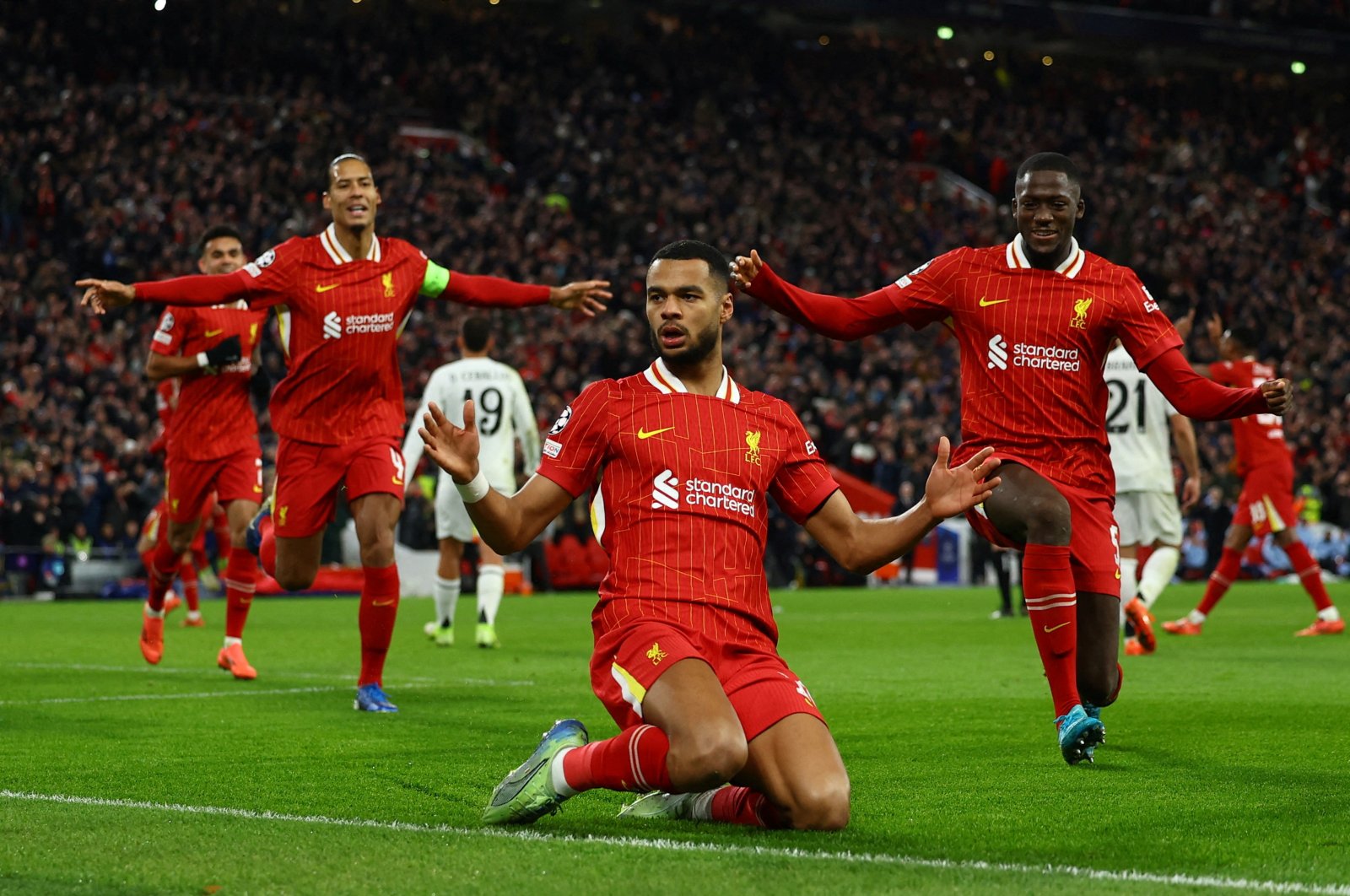 Liverpool&#039;s Cody Gakpo (C), Virgil van Dijk (L) and Ibrahima Konate celebrate after a Champions League goal against Real Madrid at Anfield, Liverpool, U.K., Nov. 27, 2024. (Reuters Photo)