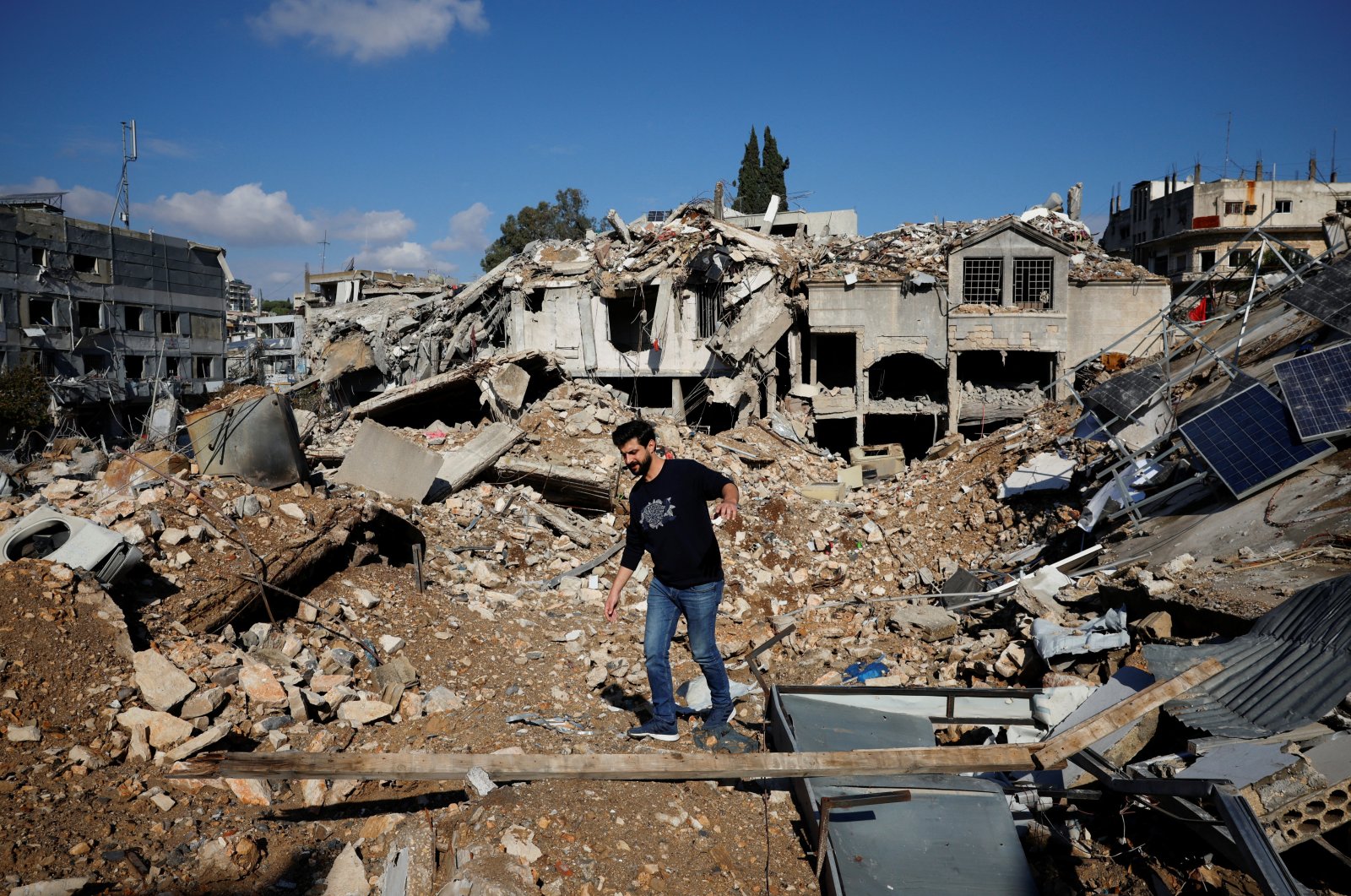 Ali Ali, 35, walks on the rubble of his shop destroyed in an Israeli strike, Nabatieh, southern Lebanon, Nov. 28, 2024. (Reuters Photo)