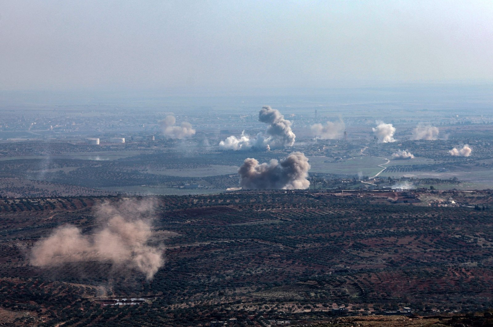 In this picture taken from the northern Syrian village of Ariha, smoke billows from the site of clashes and mutual shelling between Syrian anti-regime fighters and allied factions and regime forces on the front lines on the outskirts of the city of Saraqib in Syria&#039;s Aleppo province, Nov. 28, 2024. (AFP Photo)