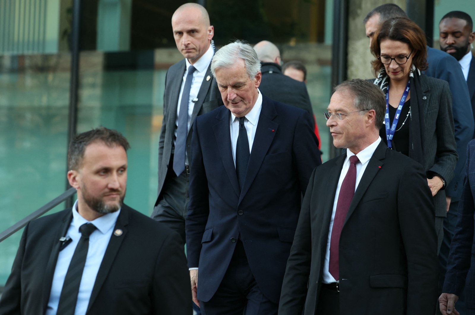 French Prime Minister Michel Barnier (C) and French General Confederation of Small and Medium Companies (CPME) President Francois Asselin (R) leave after attending the 5th Impact PME (small and medium businesses) event at the Station F in Paris, France, Nov. 28, 2024. (AFP Photo)