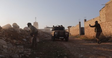 Opposition fighters fire toward Syrian Army troops in the Rashidin district on the outskirts of Aleppo, Nov. 29, 2024. (AFP Photo)