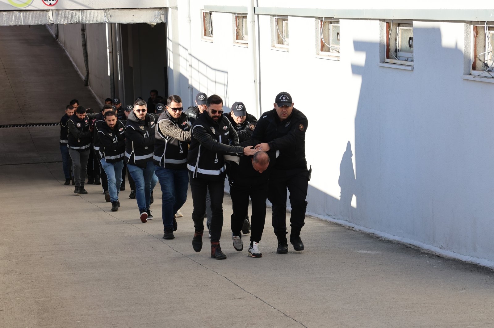 Police arrest suspects charged with depositing counterfeit money into ATMs of three banks, in the southern Adana province, Türkiye, Nov. 29, 2024. (IHA Photo)