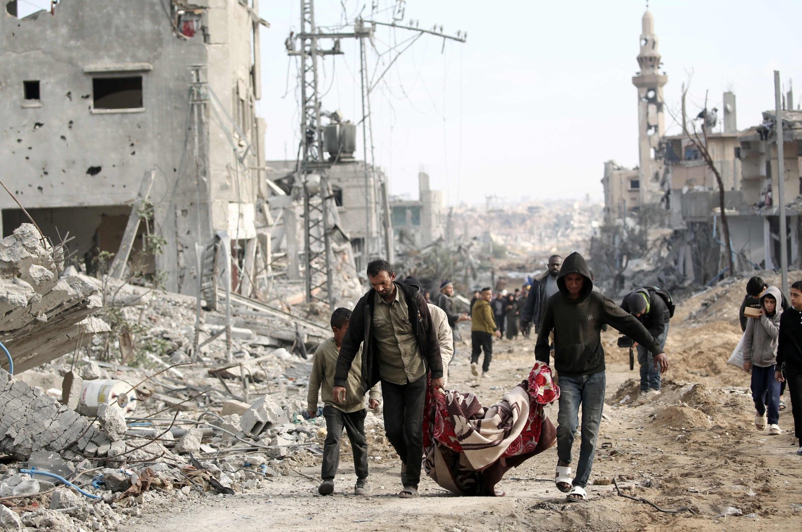 Palestinian men carry a body retrieved from under the rubble following their return to Nuseirat after Israeli shelling of the camp stopped, central Gaza Strip, Palestine, Nov. 29, 2024. (AFP Photo)