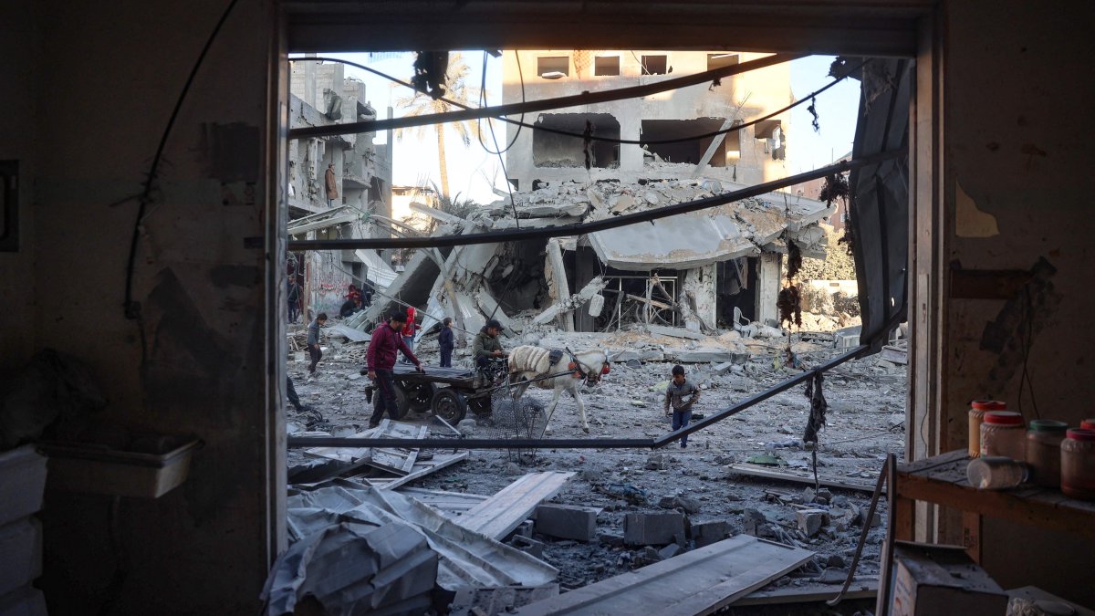 Palestinians check the devastation in front building destroyed in an Israeli airstrike in Nuseirat, central Gaza Strip, Palestine, Dec. 1, 2024. (AFP Photo)