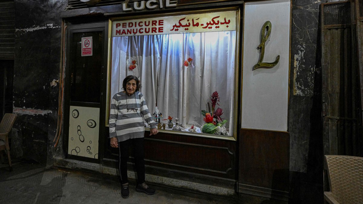 Madam Lucie, an 88-year-old manicurist expert, poses for a picture at her manicure shop in downtown Cairo, Egypt, Nov. 18, 2024. (AFP Photo)