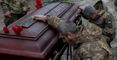 Ukrainian army members mourn next to the coffin of Pavlo Vedybida, a Ukrainian serviceman and ultras member of Football Club Obolon Kyiv, Kyiv, Ukraine, Nov. 30, 2024. (AFP Photo)