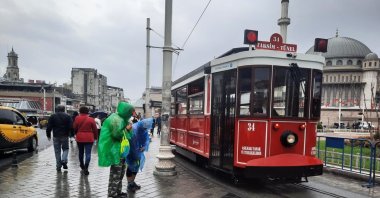 People walk close to Taksim Square on a rainy day in Istanbul, Türkiye, Nov. 21, 2024. (IHA Photo)