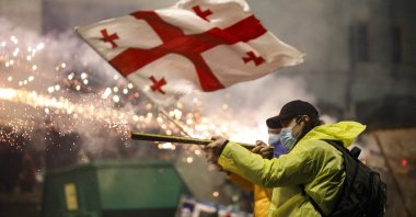 Georgian protesters launch fireworks toward the police during a demo in front of the parliament building in Tbilisi, Georgia, Nov. 30, 2024. (EPA Photo)