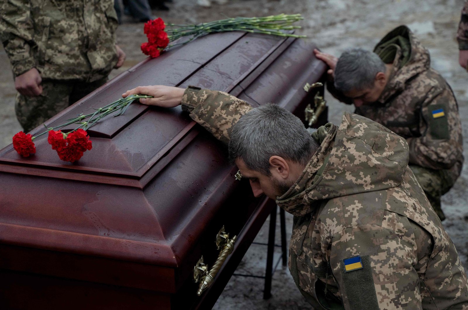 Ukrainian army members mourn next to the coffin of Pavlo Vedybida, a Ukrainian serviceman and ultras member of Football Club Obolon Kyiv, Kyiv, Ukraine, Nov. 30, 2024. (AFP Photo)