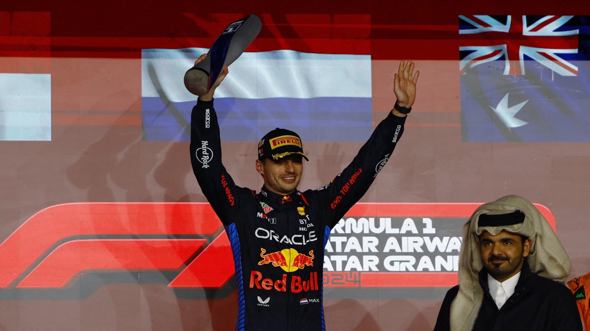 Red Bull&#039;s Max Verstappen celebrates with a trophy on the podium after winning the Qatar Grand Prix at the Lusail International Circuit, Lusail, Qatar, Dec. 1, 2024. (Reuters Photo)