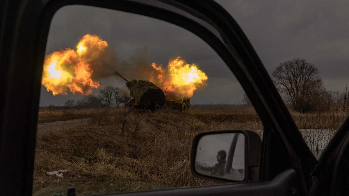 A Ukrainian soldier reflected in a car mirror looks on as a Swedish-made Archer Howitzer operated by the 45th Artillery Brigade fires toward Russian positions, Donetsk region, Ukraine, Jan. 20, 2024. (AFP Photo)