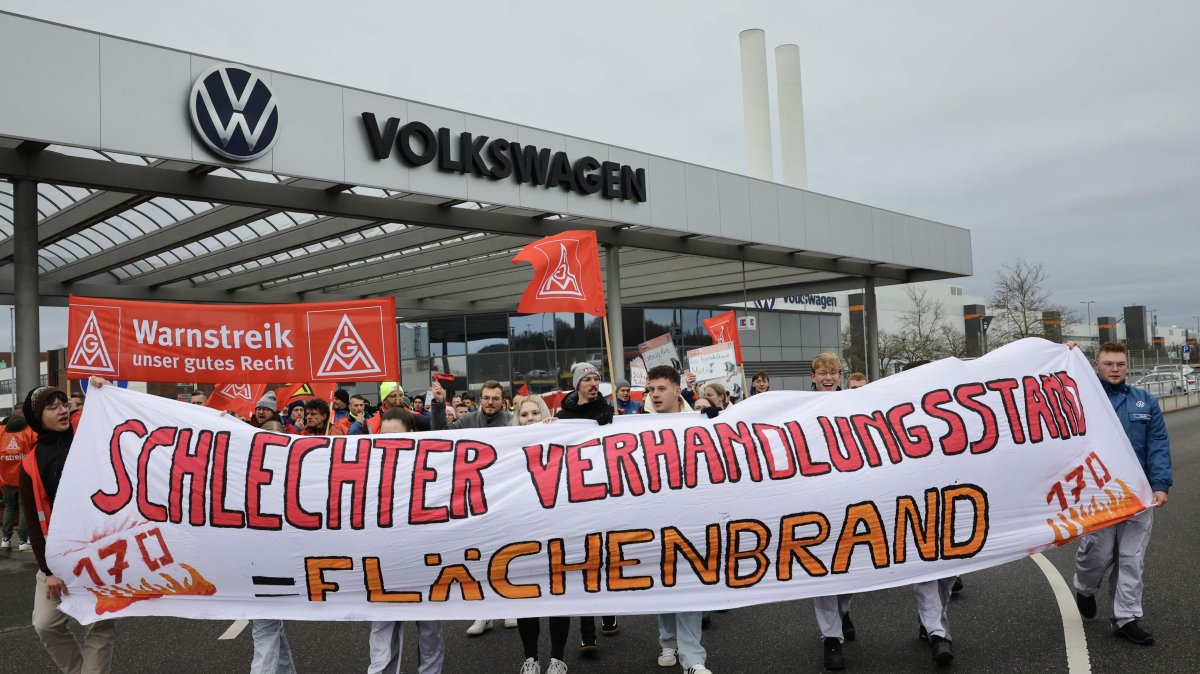 Employees of Volkswagen demonstrate with a banner of IG Metall union reading "Poor state of negotiations equals wildfire" in front of the VW plant in Zwickau, Germany, Dec. 2, 2024. (AFP Photo)