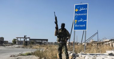 An anti-regime forces member as he stands at the entrance of Saraqeb town, Idlib, Syria, Dec. 1, 2024. (Reuters Photo)