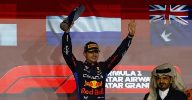 Red Bull&#039;s Max Verstappen celebrates with a trophy on the podium after winning the Qatar Grand Prix at the Lusail International Circuit, Lusail, Qatar, Dec. 1, 2024. (Reuters Photo)