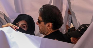 Former Pakistan Prime Minister Imran Khan (C) with his wife Bushra Bibi (L) arrive to appear at a high court in Lahore, Pakistan, May 15, 2023. (AFP Photo)