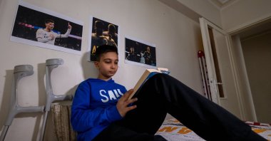 Türkiye's young amputee football player Kerem Demez sits in his room, Ankara, Türkiye, Nov. 27, 2024. (AA Photo)