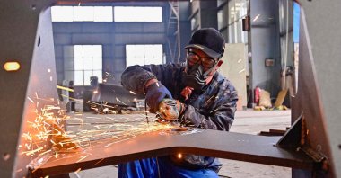 A worker works on a loader production line at a factory in Qingzhou, in eastern China&#039;s Shandong province, Nov. 15, 2024. (AFP Photo)