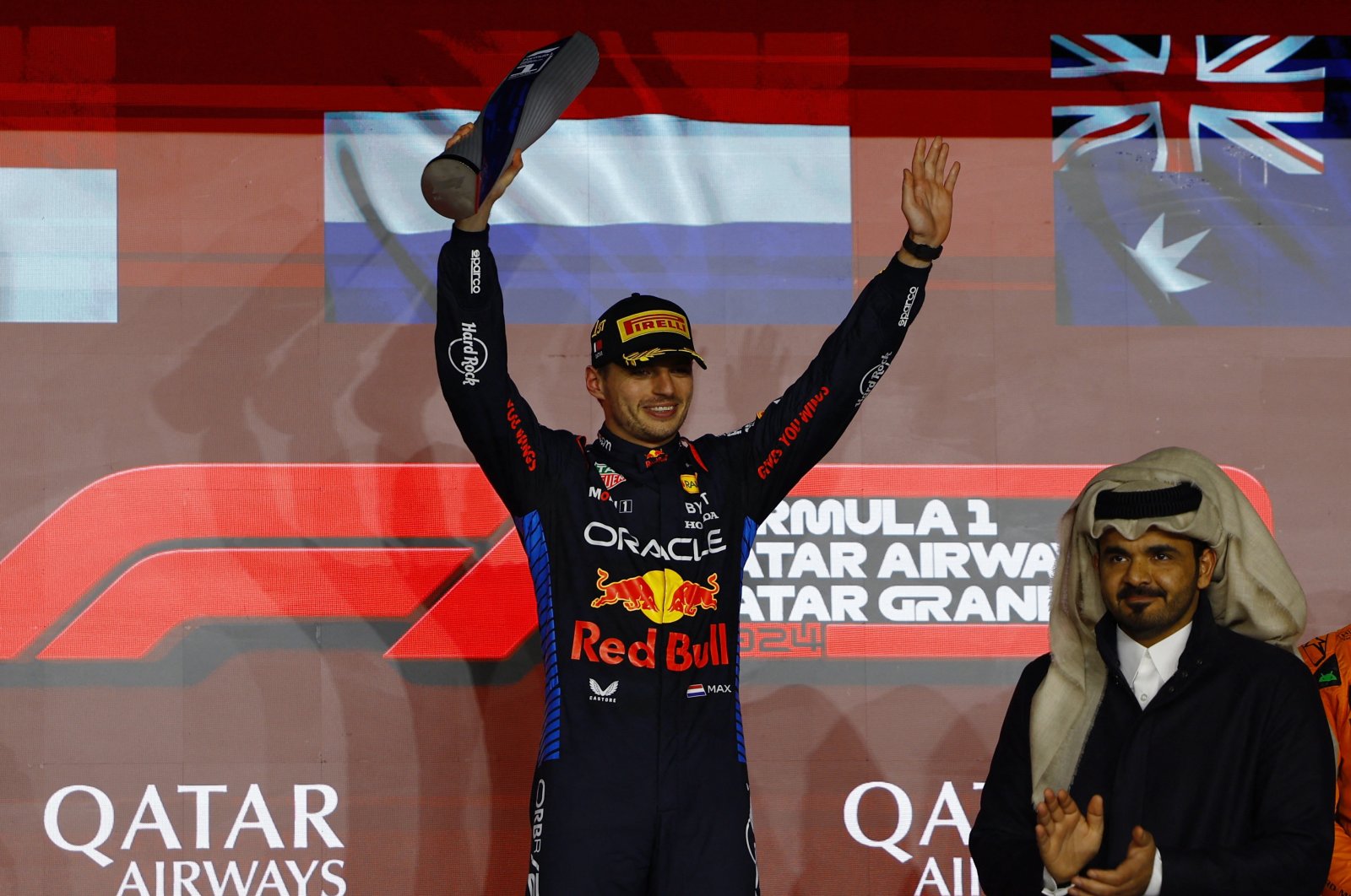 Red Bull&#039;s Max Verstappen celebrates with a trophy on the podium after winning the Qatar Grand Prix at the Lusail International Circuit, Lusail, Qatar, Dec. 1, 2024. (Reuters Photo)