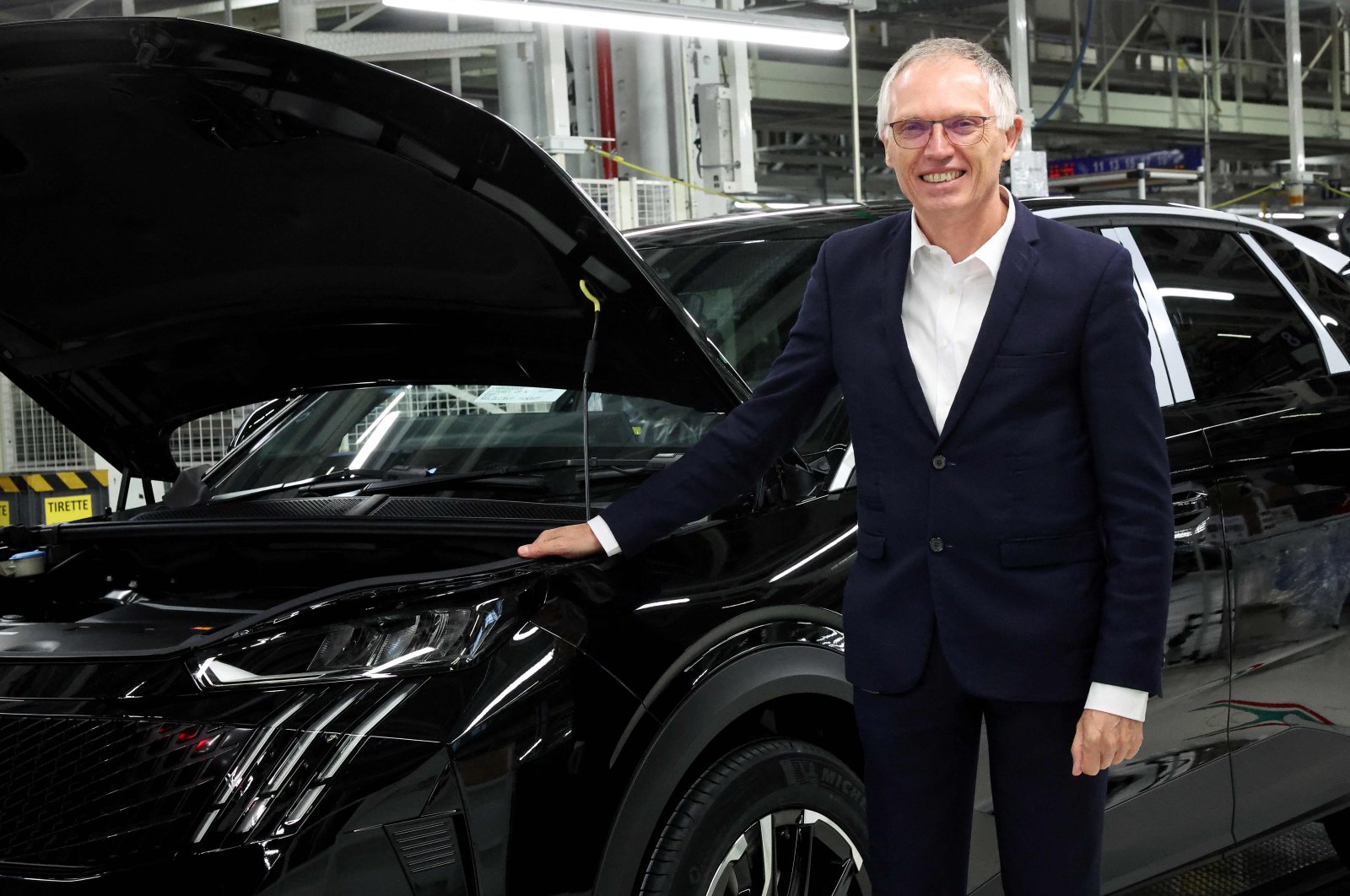 Stellantis CEO Carlos Tavares poses at the production line of the new Peugeot e-3008 and e-5008 electric car at the Stellantis car factory in Sochaux, France, Oct. 3, 2024. (AFP Photo)