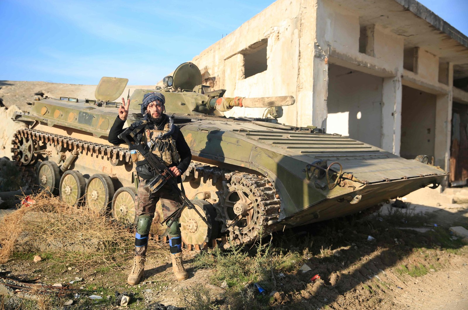 An opposition fighter poses next to an armored carrier in Tal Rifaat, northern Syria, Dec. 2, 2024. (AFP Photo)