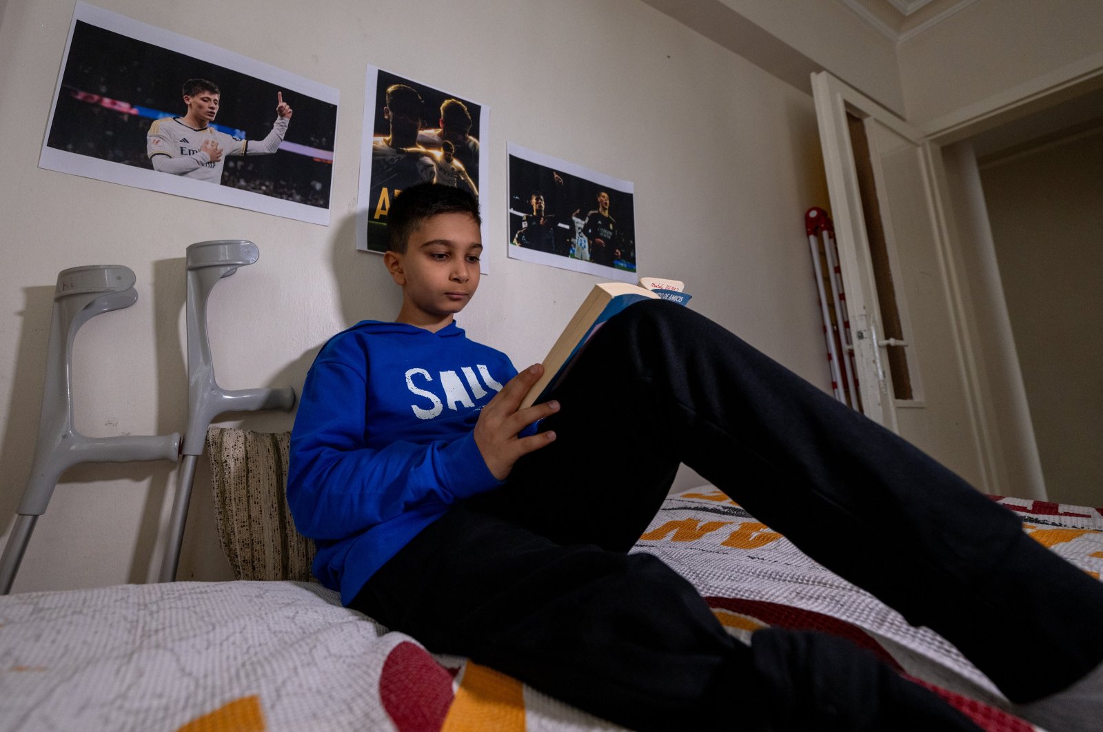 Türkiye&#039;s young amputee football player Kerem Demez sits in his room, Ankara, Türkiye, Nov. 27, 2024. (AA Photo)