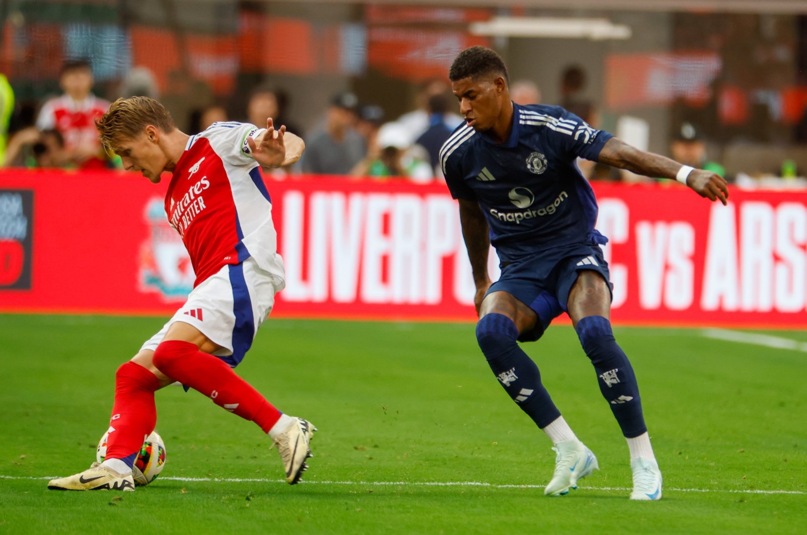 Arsenal&#039;s Martin Odegaard (L) in actions against Manchester United&#039;s Marcus Rashford during a friendly football match at Sofi Stadium, Inglewood, California, U.S., July 27, 2024. (Shutterstock Photo)