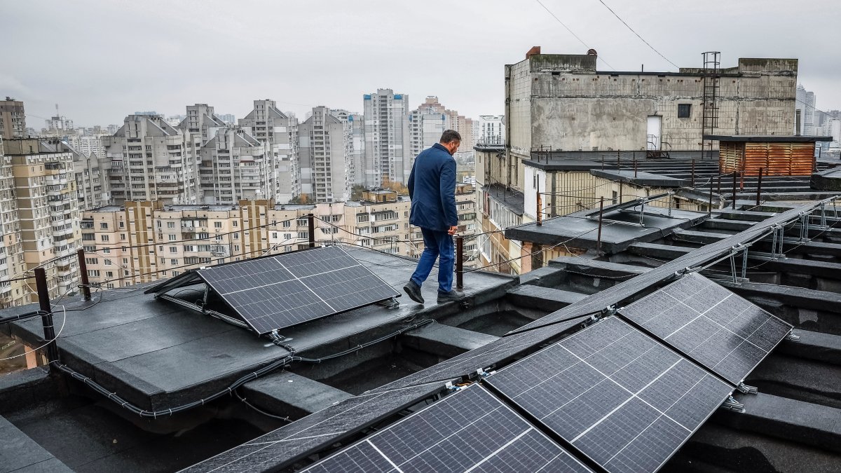 Valerii Pyndyk, head of a housing association board, appears on the roof of an apartment building, where solar panels were installed, in Kyiv, Ukraine, Nov. 14, 2024. (Reuters Photo)