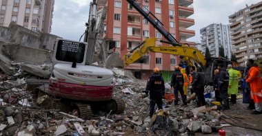 Emergency teams search for people in the rubble of a destroyed building, Adana, southern Türkiye, Feb. 6, 2023. (AP Photo)