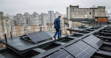 Valerii Pyndyk, head of a housing association board, appears on the roof of an apartment building, where solar panels were installed, in Kyiv, Ukraine, Nov. 14, 2024. (Reuters Photo)