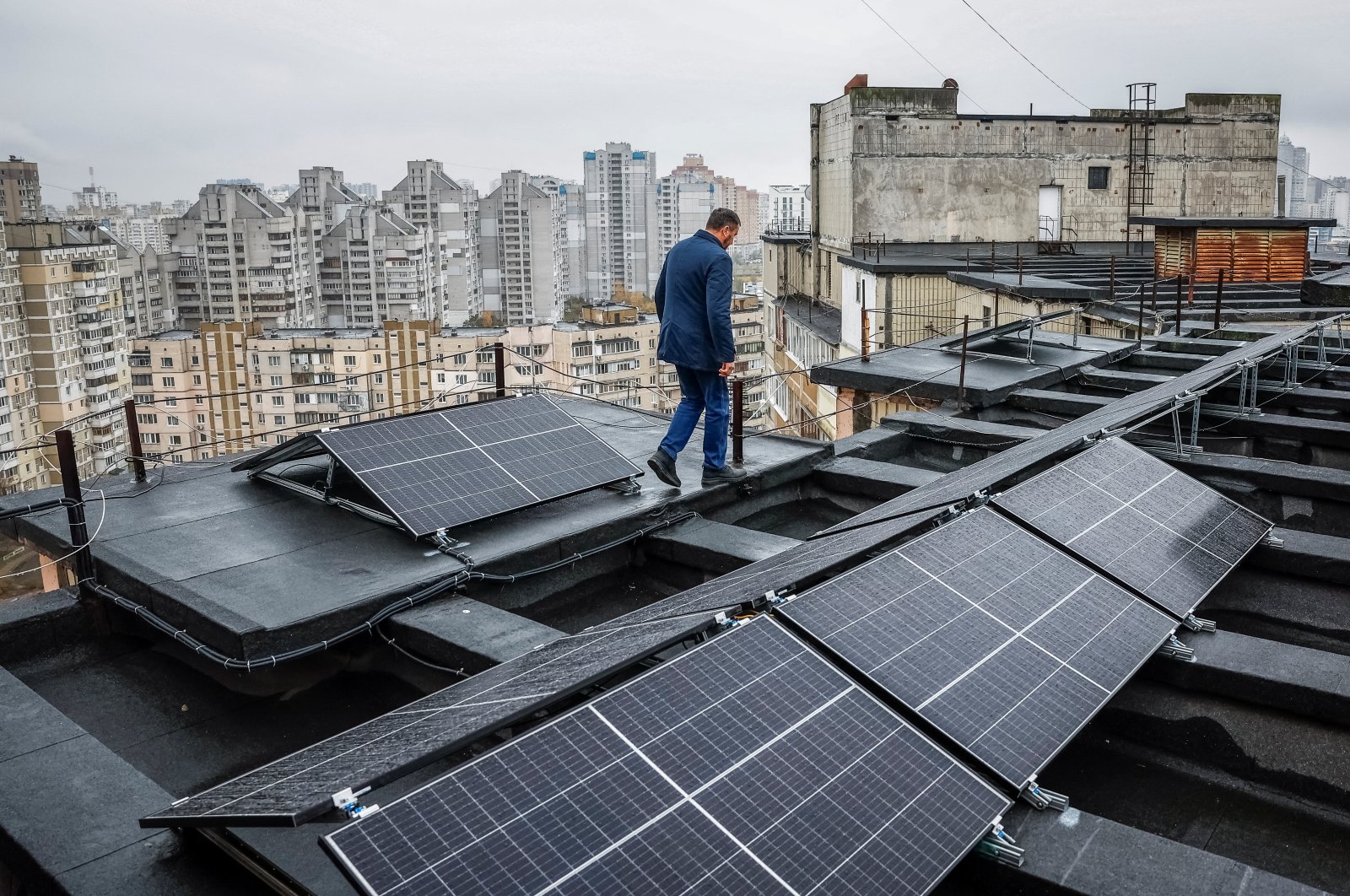 Valerii Pyndyk, head of a housing association board, appears on the roof of an apartment building, where solar panels were installed, in Kyiv, Ukraine, Nov. 14, 2024. (Reuters Photo)