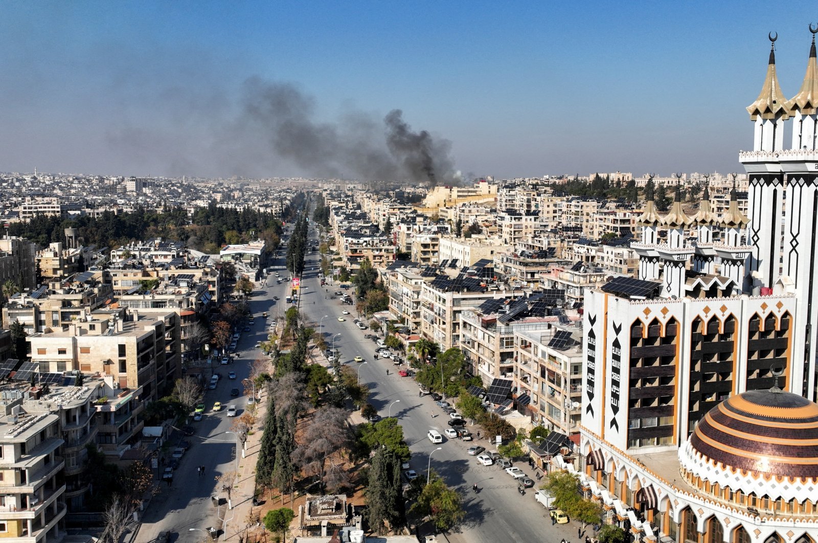 Smoke billows near residential buildings in a picture taken from a drone in Aleppo, Syria Dec.3, 2024. (Reuters Photo)