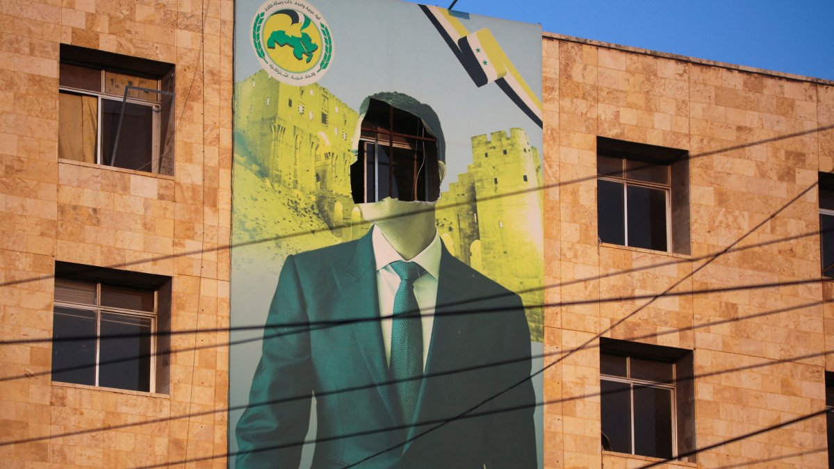 A view shows a damaged poster of Syrian regime leader Bashar Assad in Aleppo, after the Syrian army said that dozens of its soldiers had been killed in a major attack by anti-regime fighters who swept into the city, Aleppo, Syria, Nov. 30, 2024. (Reuters Photo)