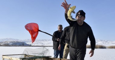 Fishermen break the ice on the surface of Hafif Lake to fish in the traditional Eskimo style, Sivas, eastern Türkiye, Nov. 3, 2024. (DHA Photo)