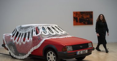 A woman walks past an artwork by Jasleen Kaur during the Turner Prize 2024 press preview at Tate Britain, London, Tuesday, Sept. 24, 2024. (AP Photo)