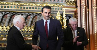 Qatar's Emir Sheikh Tamim bin Hamad Al Thani (C) is applauded by Speaker of the House of Commons Lindsay Hoyle (R) and Speaker of the House of Lords John McFall during a visit to the Palace of Westminster in London, U.K., Dec. 3, 2024. (AFP Photo)