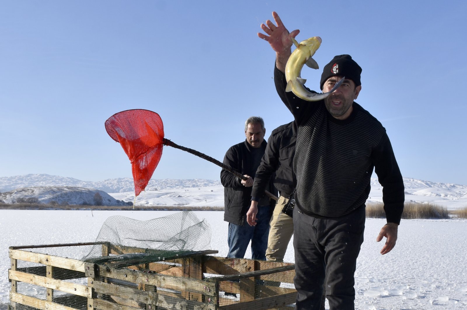 Fishermen break the ice on the surface of Hafif Lake to fish in the traditional Eskimo style, Sivas, eastern Türkiye, Nov. 3, 2024. (DHA Photo)