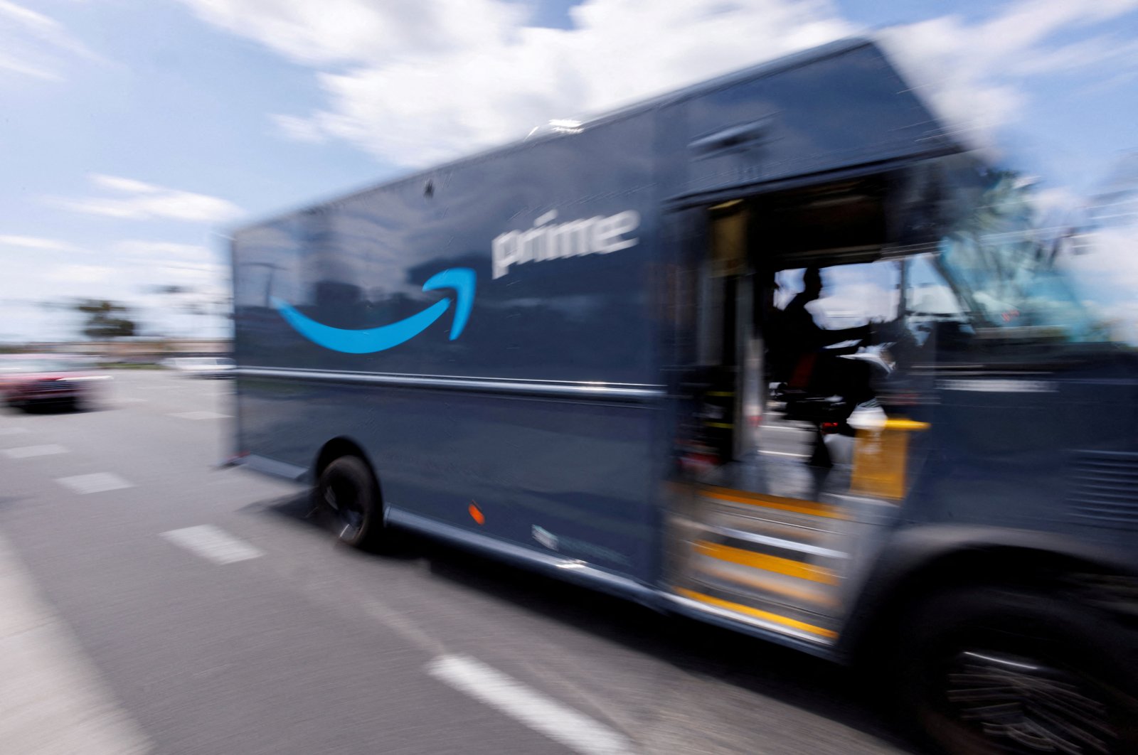 An Amazon Prime delivery van is driven along a city street in Garden Grove, California, U.S., March 29, 2022. (Reuters Photo)