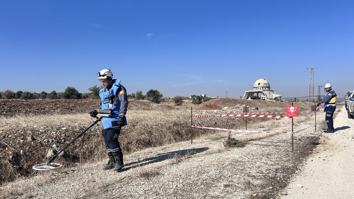 White Helmets members scan a road for explosives planted by PKK/YPG terrorists in liberated Tal Rifaat, Syria, Dec. 4, 2024. (İHA Photo)