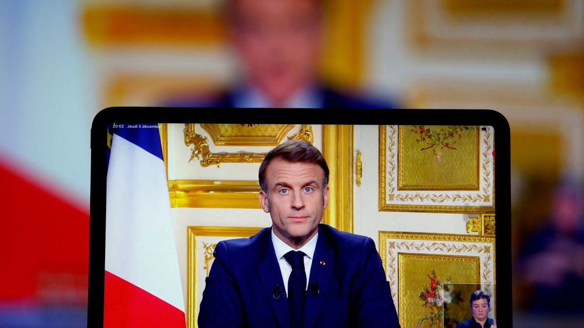 French President Emmanuel Macron appears on screen as he makes a television address to the nation after Prime Minister Michel Barnier&#039;s government was toppled in a no-confidence vote in parliament in Paris, France, Dec. 5, 2024. (Reuters Photo)