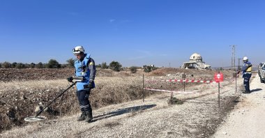 White Helmets members scan a road for explosives planted by PKK/YPG terrorists in liberated Tal Rifaat, Syria, Dec. 4, 2024. (İHA Photo)
