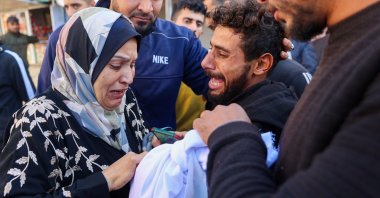 A woman reacts as she checks the body of a 2-year-old child who was killed in an Israeli airstrike in Gaza City, central Gaza, Palestine, Dec. 5, 2024. (AFP Photo)